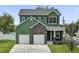 Beautiful two-story green house with stone accents and a two-car garage at 2731 Coventry Ave, Lakeland, FL 33803