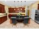 Open kitchen boasts granite counters, dark wood cabinets, and an island with seating at 2731 Coventry Ave, Lakeland, FL 33803