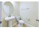 Small powder room with pedestal sink and toilet at 3484 Julius Estates Blvd, Winter Haven, FL 33881