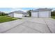 Single-story house with attached garage and spacious driveway at 4510 Roundup Dr, Polk City, FL 33868
