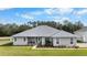 Single-story house with a grey exterior and landscaped yard at 4510 Roundup Dr, Polk City, FL 33868
