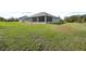 Rear view of a house with a screened-in porch and yard at 4510 Roundup Dr, Polk City, FL 33868