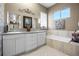 Spa-like bathroom with double vanity, large soaking tub, and shower at 4510 Roundup Dr, Polk City, FL 33868