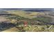 Aerial view showing home's location in a rural area with fields and trees at 4510 Roundup Dr, Polk City, FL 33868