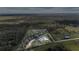 Aerial view highlighting a house with a large lot and surrounding trees at 4510 Roundup Dr, Polk City, FL 33868