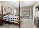 Main bedroom with sliding doors to the backyard and a large ceiling fan at 4510 Roundup Dr, Polk City, FL 33868