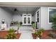 Inviting front porch features double doors, planters, and fall decor at 4510 Roundup Dr, Polk City, FL 33868