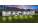 Attractive single-story home with attached garage at dusk at 4510 Roundup Dr, Polk City, FL 33868