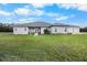 House exterior with landscaping and a large yard at 4510 Roundup Dr, Polk City, FL 33868