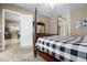 Main bedroom with a view of the kitchen and access to the ensuite bathroom at 4510 Roundup Dr, Polk City, FL 33868