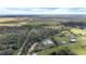 Aerial view of a house with a large lot, pond, and surrounding trees at 4510 Roundup Dr, Polk City, FL 33868