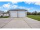 Two-car detached garage with white doors and gray exterior at 4510 Roundup Dr, Polk City, FL 33868