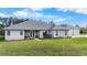 Single-story house with a two-car garage, well-maintained landscaping at 4510 Roundup Dr, Polk City, FL 33868