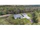 Single-story home with a detached garage and a pond view at 4510 Roundup Dr, Polk City, FL 33868