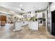 Spacious kitchen featuring an island, white cabinetry, and stainless steel appliances at 4510 Roundup Dr, Polk City, FL 33868