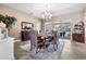 Elegant dining room features a chandelier, hardwood floors, and a large table at 4510 Roundup Dr, Polk City, FL 33868