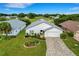 Single-story house with a paved driveway and a manicured lawn, near a golf course at 6250 Sandpipers Dr, Lakeland, FL 33809
