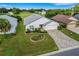 Aerial view of a house with a paved driveway and landscaped yard at 6250 Sandpipers Dr, Lakeland, FL 33809