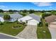 Aerial view of a house with a paved driveway and landscaped yard at 6250 Sandpipers Dr, Lakeland, FL 33809