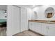 Updated bathroom with double vanity, granite countertop, and large closet at 6250 Sandpipers Dr, Lakeland, FL 33809