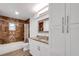 Updated bathroom with granite vanity and brown tile at 6250 Sandpipers Dr, Lakeland, FL 33809