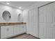 Bright bathroom with double vanity, granite countertop, and walk-in closet at 6250 Sandpipers Dr, Lakeland, FL 33809