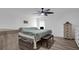 Main bedroom with a king-size bed, two dressers, and ceiling fan at 6250 Sandpipers Dr, Lakeland, FL 33809