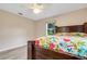 Bright bedroom with floral bedding and wood flooring at 6250 Sandpipers Dr, Lakeland, FL 33809