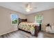 Bedroom with two windows, ceiling fan, and floral bedding at 6250 Sandpipers Dr, Lakeland, FL 33809