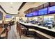 Modern bar with multiple screens and seating area at 6250 Sandpipers Dr, Lakeland, FL 33809