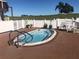 Small oval-shaped community pool with a surrounding patio at 6250 Sandpipers Dr, Lakeland, FL 33809