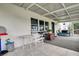 Covered patio with rocking chairs and outdoor seating at 6250 Sandpipers Dr, Lakeland, FL 33809