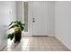 Bright entryway with tile flooring, a potted plant, and a white door at 6250 Sandpipers Dr, Lakeland, FL 33809
