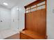 Coat rack with bench, next to an entry door and adjacent to tile floor at 6250 Sandpipers Dr, Lakeland, FL 33809