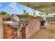Outdoor grilling station with stainless steel grills and brickwork at 6250 Sandpipers Dr, Lakeland, FL 33809