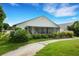 White house back with screened porch and lush landscaping at 6250 Sandpipers Dr, Lakeland, FL 33809