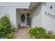 House entrance with a welcoming sign, flowers and a brick walkway at 6250 Sandpipers Dr, Lakeland, FL 33809