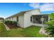 White house side with screened porch and well-maintained landscaping at 6250 Sandpipers Dr, Lakeland, FL 33809