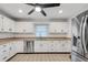 Modern kitchen with white cabinets, stainless steel appliances, and tile floors at 6250 Sandpipers Dr, Lakeland, FL 33809