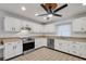Bright kitchen features white cabinets, stainless steel appliances, and light countertops at 6250 Sandpipers Dr, Lakeland, FL 33809