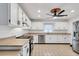 Modern kitchen with white cabinets, stainless steel appliances, and tile floors at 6250 Sandpipers Dr, Lakeland, FL 33809