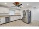 Modern kitchen with white cabinets, stainless steel appliances, and tile floors at 6250 Sandpipers Dr, Lakeland, FL 33809
