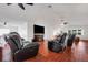 Large living room with hardwood floors, ceiling fans and black leather recliners at 6250 Sandpipers Dr, Lakeland, FL 33809
