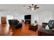 Living room with hardwood floors, ceiling fans, and black leather recliners at 6250 Sandpipers Dr, Lakeland, FL 33809