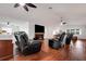 Open living room featuring hardwood floors, fireplace, and large TV at 6250 Sandpipers Dr, Lakeland, FL 33809
