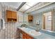 Double vanity bathroom with wood cabinets and updated fixtures at 6256 Sandpipers Dr, Lakeland, FL 33809