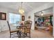 Bright dining room features a glass table with four chairs and views into a sunroom at 6256 Sandpipers Dr, Lakeland, FL 33809