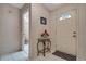 Bright entryway with tile flooring, a glass-top table, and access to a bathroom at 6256 Sandpipers Dr, Lakeland, FL 33809