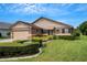 House exterior with two-car garage and manicured lawn at 6256 Sandpipers Dr, Lakeland, FL 33809
