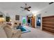 Living room with comfortable seating, built-in shelving, and a view into a bedroom at 6256 Sandpipers Dr, Lakeland, FL 33809